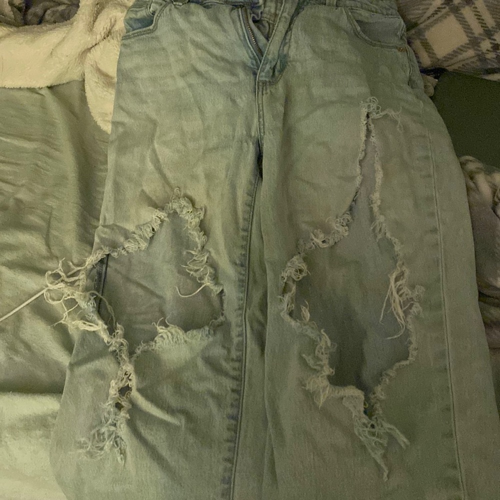 thigh ripped light blue jeans